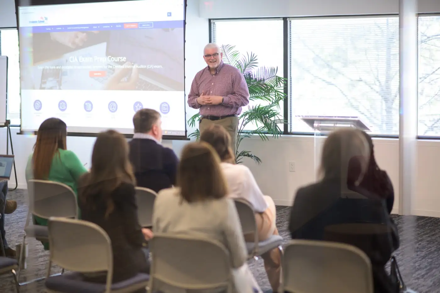 A Graduate School USA instructor leading a session in front of a projected course page
