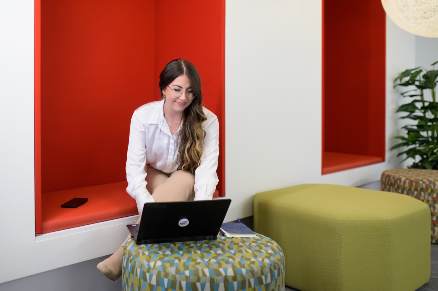 A learner studying on a laptop in a Graduate School USA workspace
